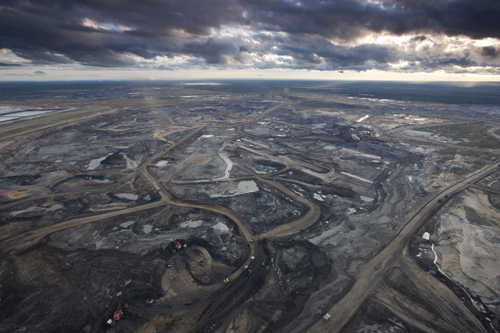 Photo of devastated landscape - all black with tarry roads and ponds